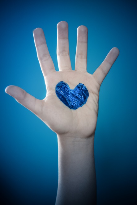 hand with blue heart for autism
